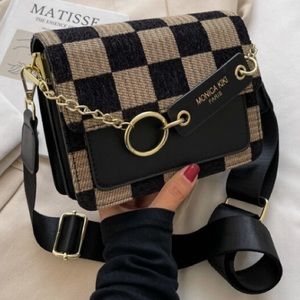 Black leather purse with beige and black checker front with inside pockets